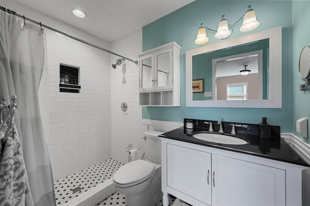 bathroom featuring toilet, a stall shower, and vanity