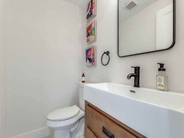 bathroom featuring toilet and vanity