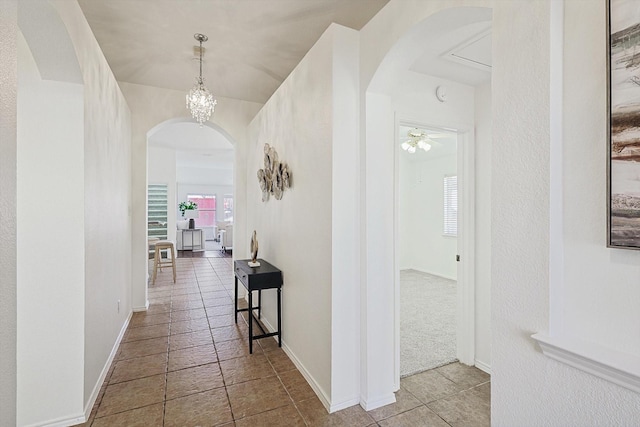 hallway with a chandelier