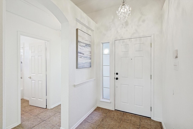 foyer entrance featuring an inviting chandelier and light tile patterned flooring