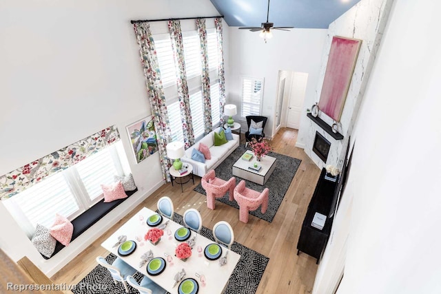 living room with a wealth of natural light, ceiling fan, and light hardwood / wood-style floors