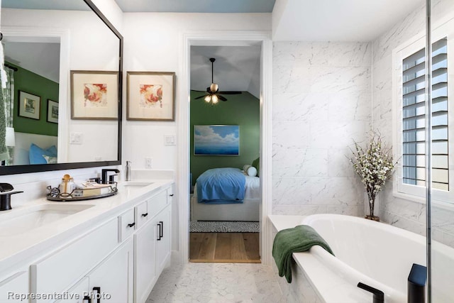 bathroom featuring vanity and tiled bath