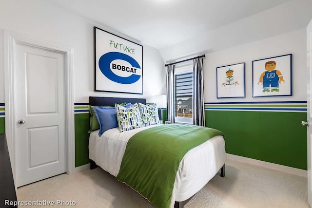 bedroom featuring light carpet and lofted ceiling