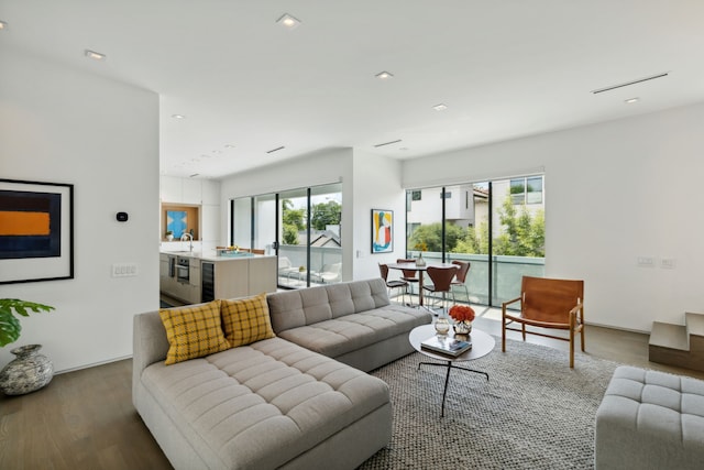 living room featuring a healthy amount of sunlight, beverage cooler, and hardwood / wood-style flooring