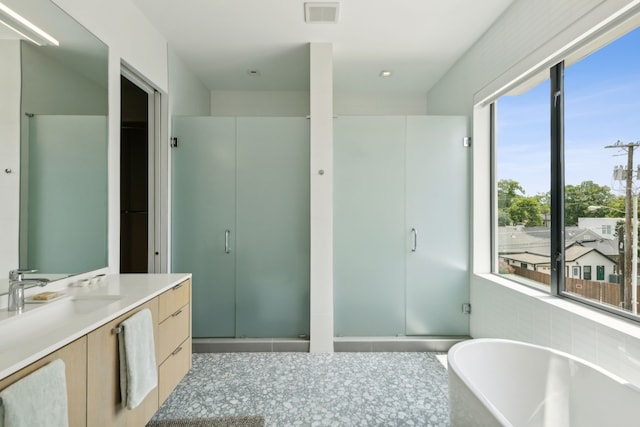 bathroom featuring plus walk in shower and vanity