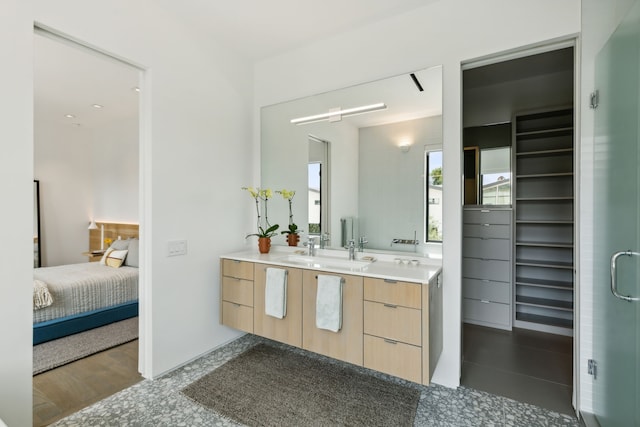 bathroom with walk in shower and vanity