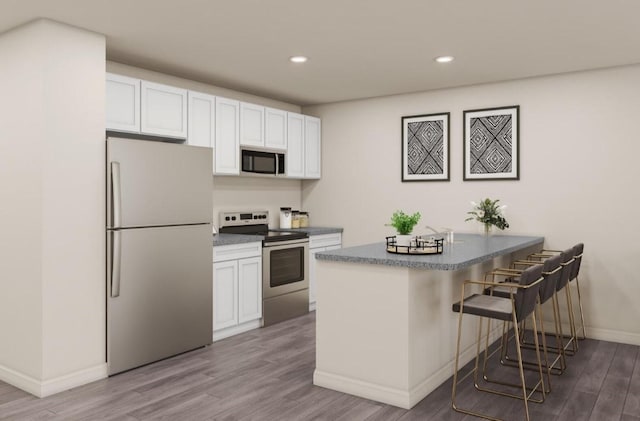 kitchen with appliances with stainless steel finishes, light wood-type flooring, white cabinets, and kitchen peninsula