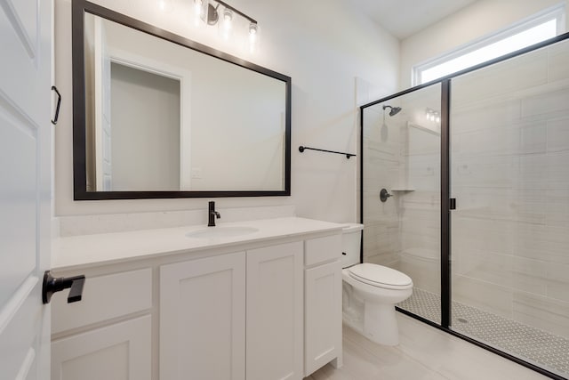 bathroom featuring a shower with door, tile patterned flooring, vanity, and toilet