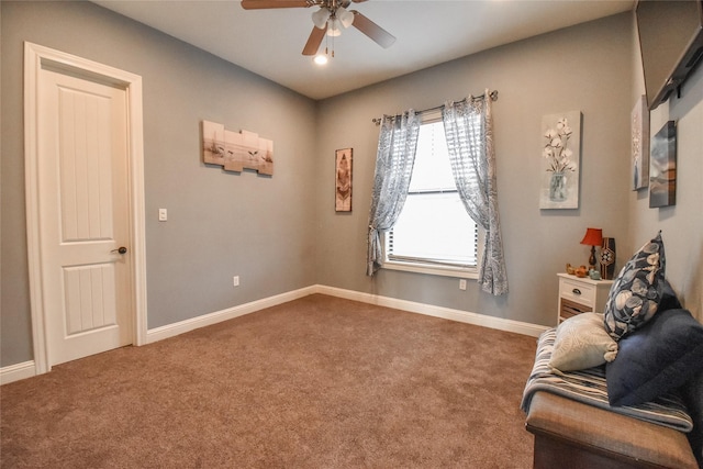 sitting room featuring ceiling fan and carpet