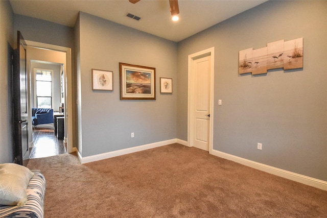 unfurnished room with ceiling fan and carpet floors