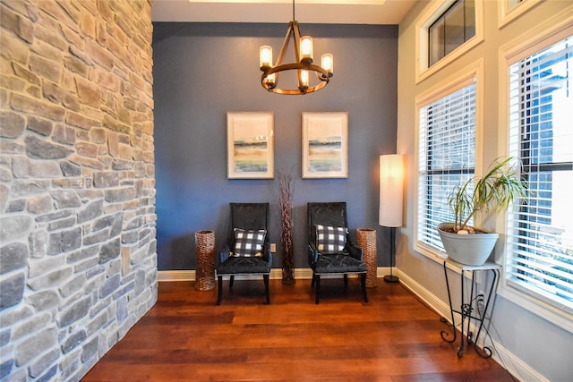 sitting room with an inviting chandelier and dark hardwood / wood-style floors