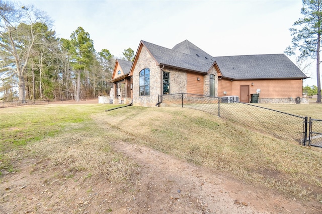 view of home's exterior with central AC and a lawn