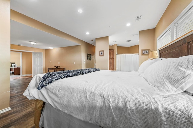 bedroom with dark hardwood / wood-style floors