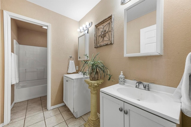 bathroom with tiled shower / bath combo, tile patterned flooring, and vanity