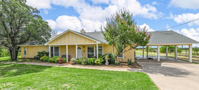 view of front facade featuring a front yard and a carport