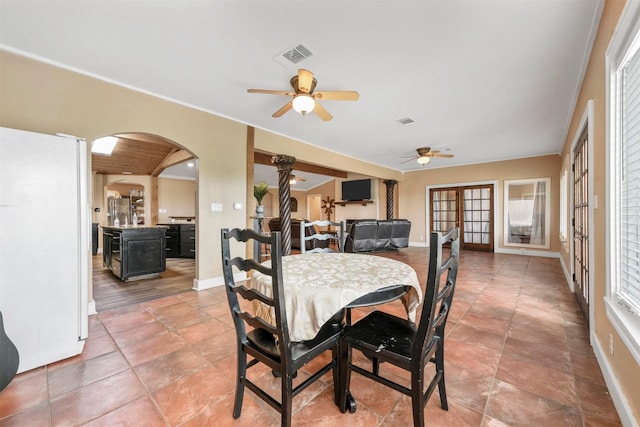 dining space with french doors, tile patterned flooring, and ceiling fan