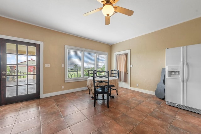 tiled dining area with ceiling fan