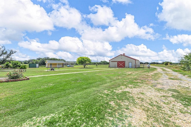 view of yard with a rural view and an outdoor structure