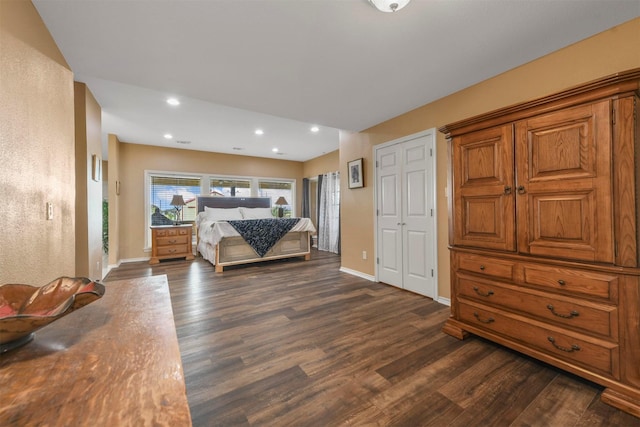 bedroom with dark hardwood / wood-style floors