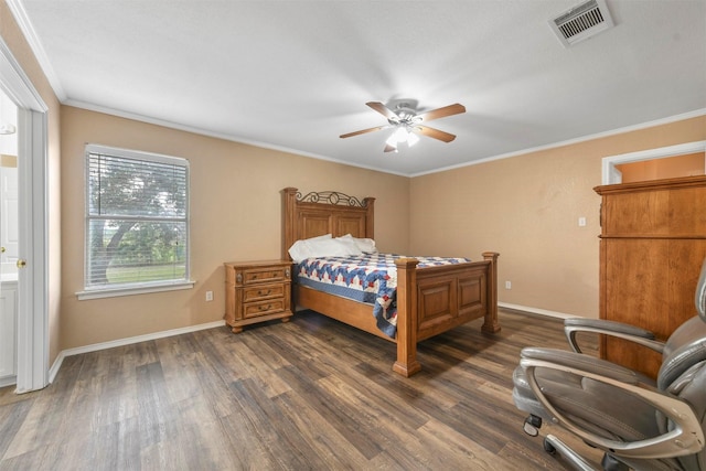 bedroom with ceiling fan, dark wood-type flooring, crown molding, and ensuite bath