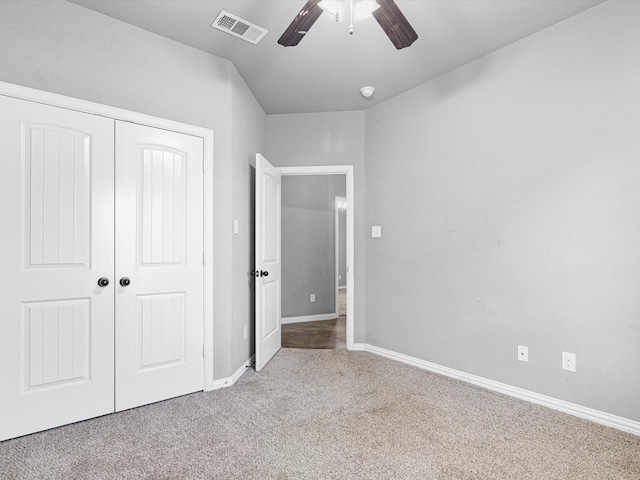 unfurnished bedroom with a closet, carpet floors, and ceiling fan