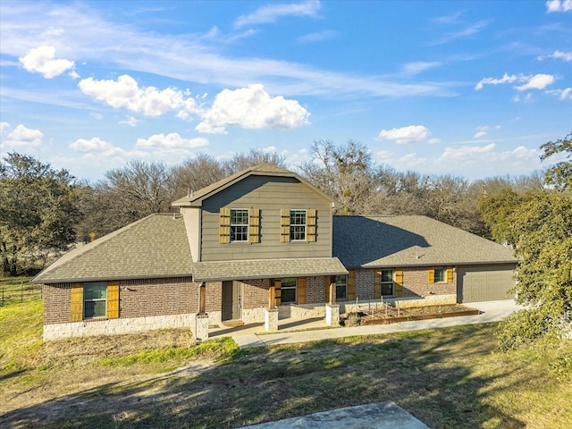 view of front facade with a front yard, a garage, and a patio area