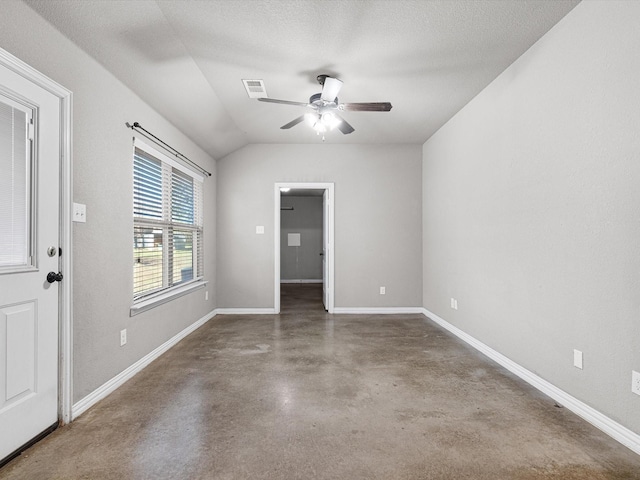 empty room featuring a textured ceiling, ceiling fan, and lofted ceiling