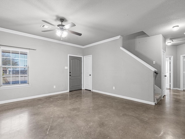 empty room featuring a textured ceiling, ceiling fan, and crown molding