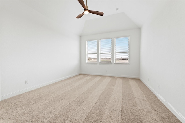 carpeted empty room with ceiling fan and vaulted ceiling