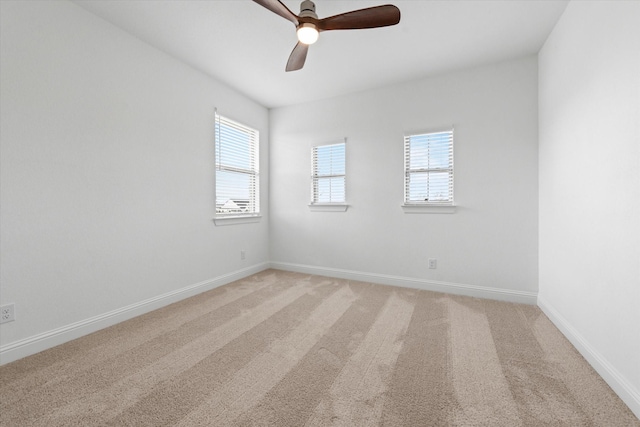 spare room featuring carpet flooring, ceiling fan, and a wealth of natural light