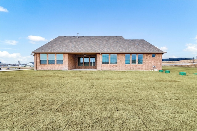 back of property featuring a lawn and a patio area