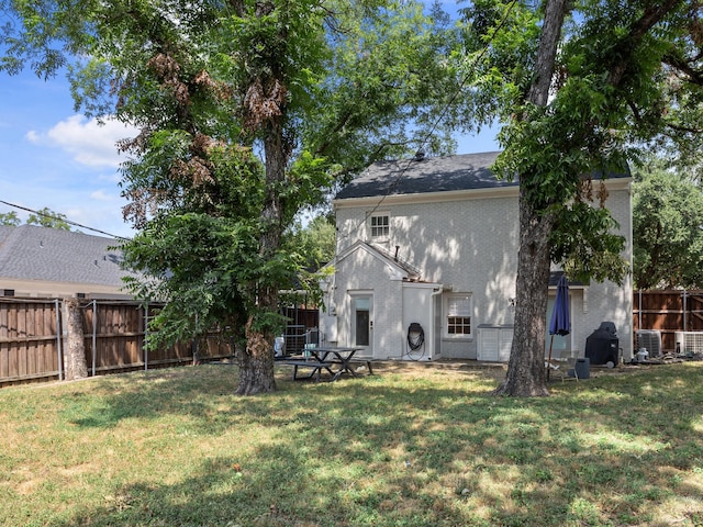 rear view of house with a lawn