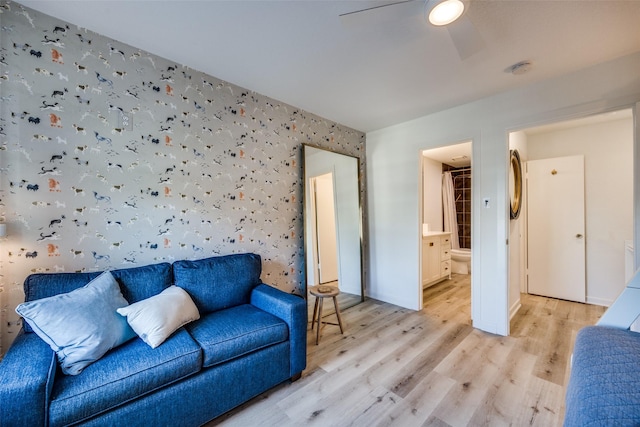 living room with ceiling fan and light hardwood / wood-style flooring