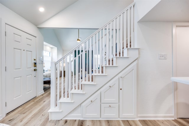 foyer entrance featuring lofted ceiling and light hardwood / wood-style floors