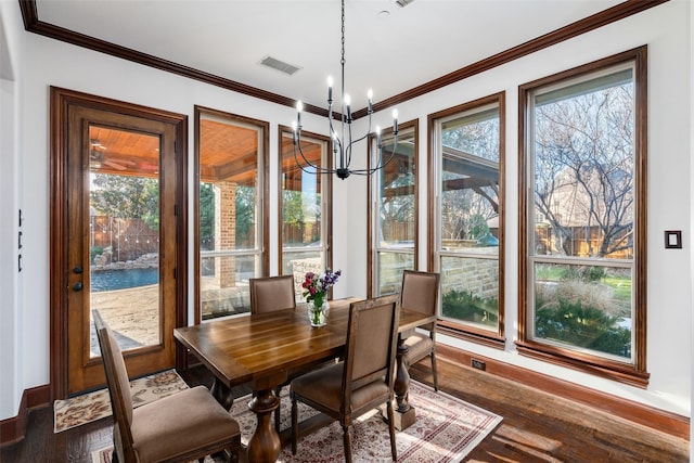 sunroom / solarium featuring an inviting chandelier