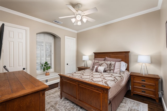 bedroom with ceiling fan, ornamental molding, and light hardwood / wood-style flooring