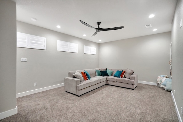 carpeted living room with ceiling fan