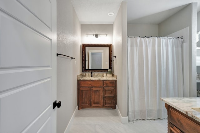 bathroom with vanity and a textured ceiling