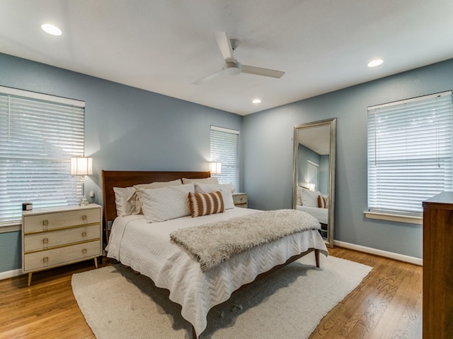 bedroom with ceiling fan and light hardwood / wood-style floors