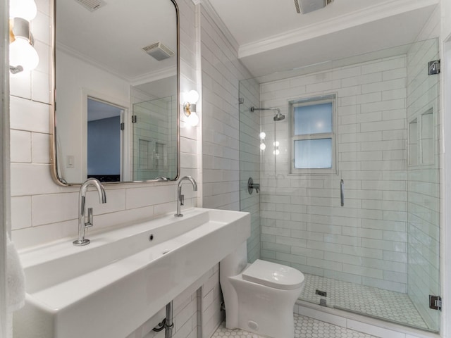 bathroom featuring toilet, backsplash, a shower with door, and crown molding