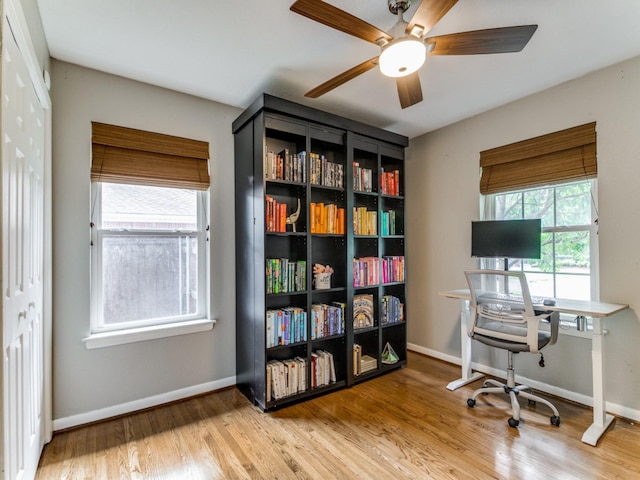 office with hardwood / wood-style floors and ceiling fan