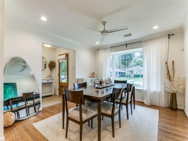 dining area featuring ornamental molding, ceiling fan, and light hardwood / wood-style floors