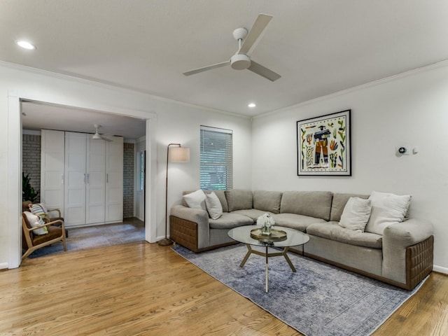 living room with ceiling fan, ornamental molding, and hardwood / wood-style flooring