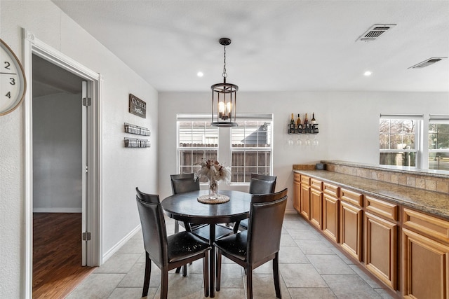 dining area featuring light tile patterned floors and a chandelier