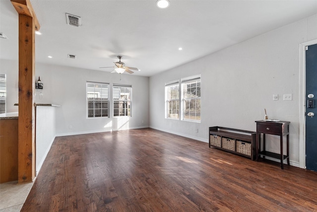 living room with ceiling fan and dark hardwood / wood-style floors