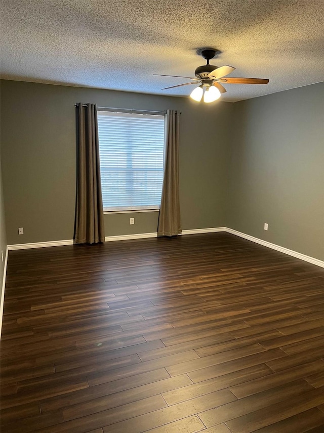 empty room with a textured ceiling, ceiling fan, and dark hardwood / wood-style floors