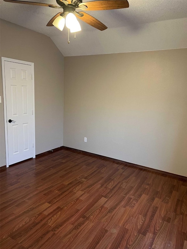 empty room featuring a textured ceiling, ceiling fan, vaulted ceiling, and dark hardwood / wood-style floors