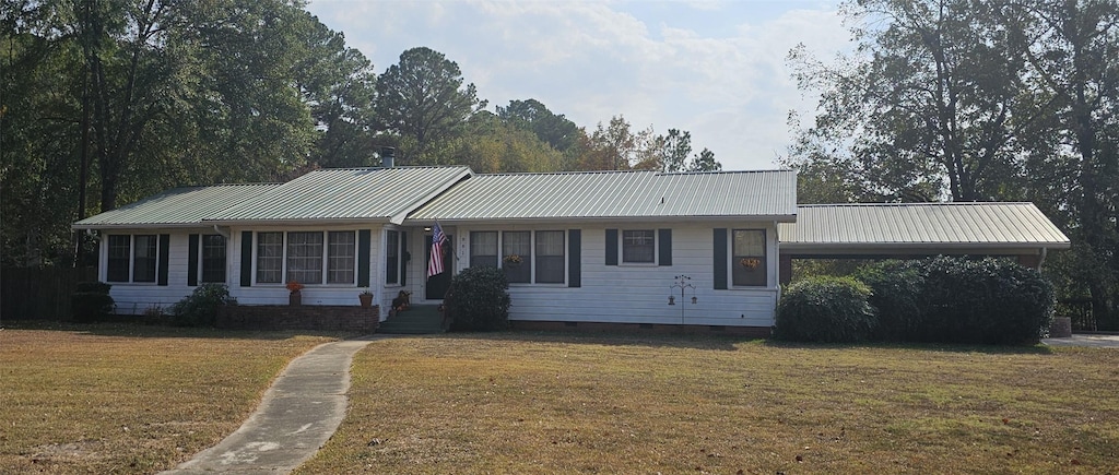 ranch-style house featuring a carport and a front yard