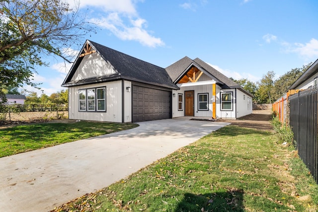 modern farmhouse with a front yard and a garage