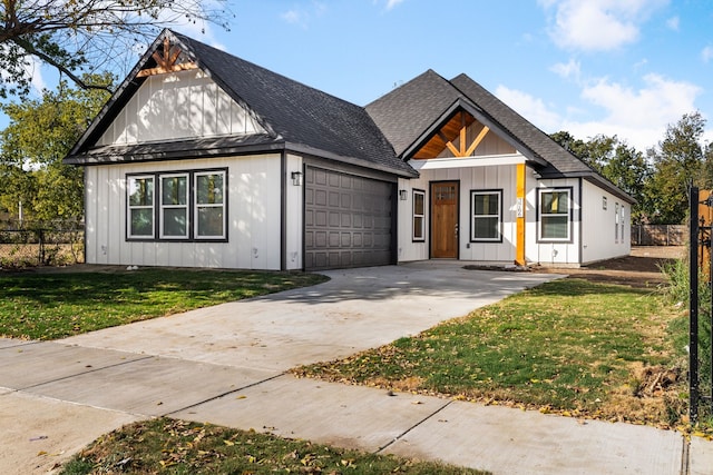 modern inspired farmhouse featuring a front yard and a garage